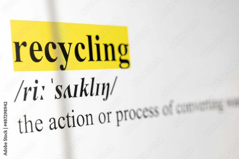 Poster recycling text macro shot highlighted in yellow color on computer screen