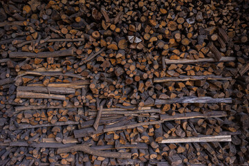 Stacked Firewood. Wooden grunge background made with wood cross sections. Natural wood log texture, wall decor. Mass of wood logs forest tree ecology industry.