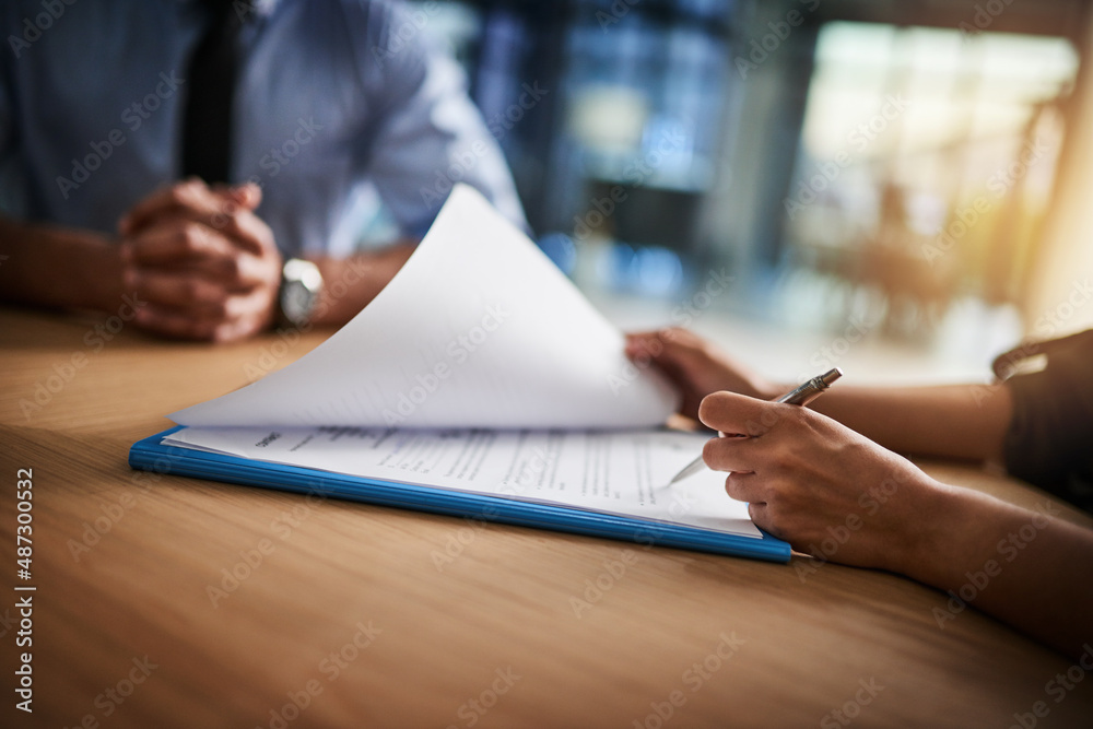 Wall mural combing through the fine print. cropped shot of a man and woman completing paperwork together at a d