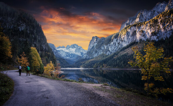 Impressive Autumn landscape during sunset. The Fusine Lake in front of the Mongart under sunlight. Amazing sunny day on the mountain lake. concept of an ideal resting place. Creative image.