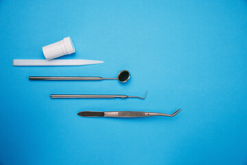 Dentist office with tools for teeth care at blue background top view close up macro. Dentist Professional tools medical equipment. Dental Care conceptual image background. Basic dentist tools.