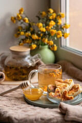Obraz na płótnie Canvas cup of tea and cookies. composition with a glass teapot and glasses filled with tea with lemon