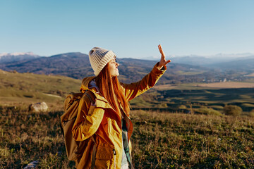 woman traveler mountain top nature travel adventure sunny day