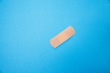 Medical patch isolated on a blue background. Healthcare concept. A medical equipment - adhesive plaster 