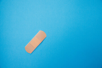 Medical patch isolated on a blue background. Healthcare concept. A medical equipment - adhesive plaster 