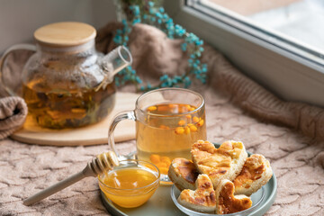 cup of tea and cookies. composition with a glass teapot and glasses filled with tea with lemon