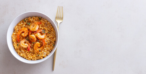 Risotto with shrimps, tomatoes and thyme. Italian food.