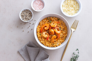 Risotto with shrimps, tomatoes and thyme. Italian food.