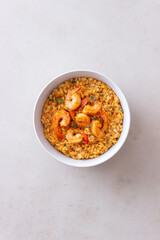 Risotto with shrimps, tomatoes and thyme. Italian food.