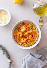 Risotto with shrimps, tomatoes and thyme. Italian food.