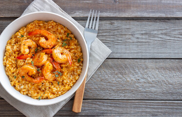 Risotto with shrimps, tomatoes and thyme. Italian food.