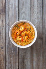 Risotto with shrimps, tomatoes and thyme. Italian food.