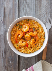 Risotto with shrimps, tomatoes and thyme. Italian food.