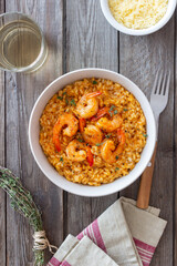 Risotto with shrimps, tomatoes and thyme. Italian food.