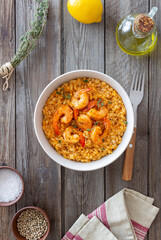 Risotto with shrimps, tomatoes and thyme. Italian food.