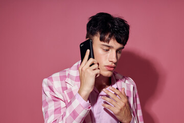 A young man self confidence pink plaid blazer fashion posing isolated background unaltered