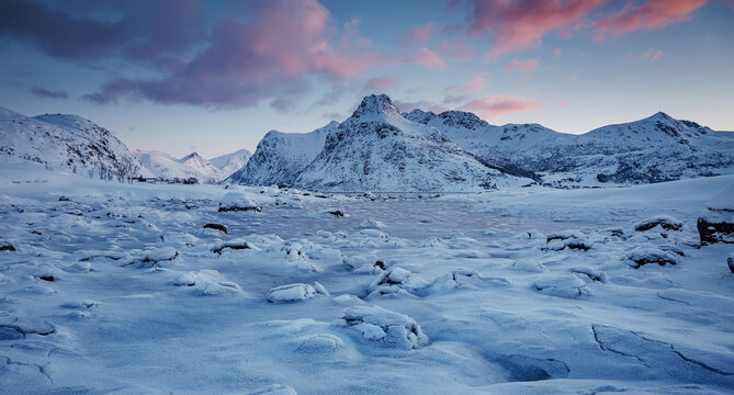 Beautiful winter landscapes in Lofoten islands, Northern Norway. wintry season. Amazing winter nature scenery. Fantastic colorful sunset over north fjord above snow covered mountains. Norwey