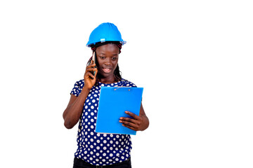 young female engineer reading notes on clipboard and talking on mobile phone.