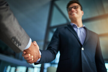 Winning negotiations how the pros do it. Cropped shot of two businessmen shaking hands in a modern office. © Arnéll K/peopleimages.com