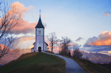 church in fresh frosty evening sun in winter mountains of the slovenian alps at sunset