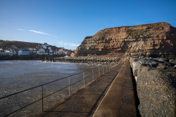 Obraz premium Staithes seaside town and sea defenses in North Yorkshire