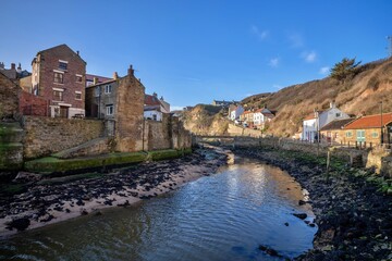 Fototapeta na wymiar Staithes seaside town and sea defenses in North Yorkshire