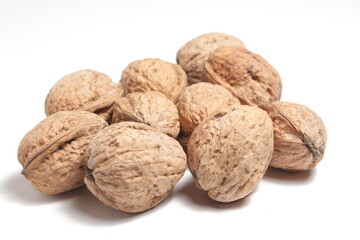 a handful of walnuts on a white background