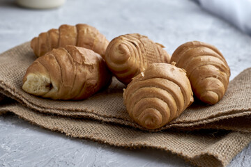 fresh croissants with chocolate filling on burlap
