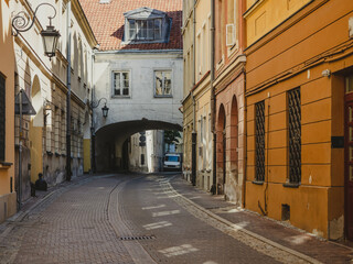 old cobblestone narrow street in historic district of Warsaw city, Poland