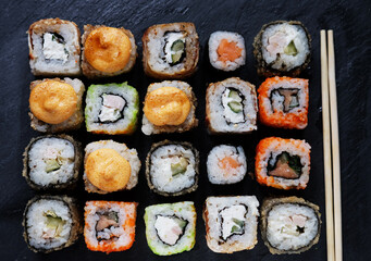Set of sushi and maki on stone table. Flat lay