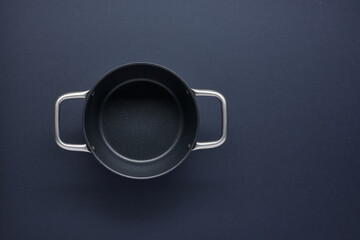 empty saucepan on black kitchen table