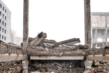 The destroyed foundation and construction debris with huge concrete fragments against the...