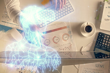 Double exposure of man's hands typing over computer keyboard and virtual reality hologram drawing. Top view. Technology concept. Future.
