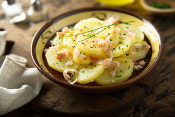 Homemade potato salad with bacon and chives