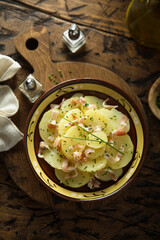 Homemade potato salad with bacon and chives
