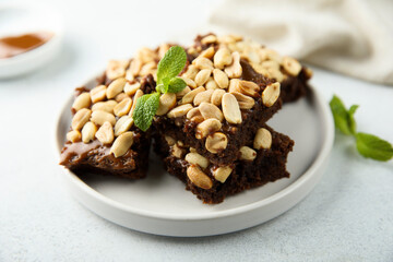 Traditional homemade brownies with caramel and peanut