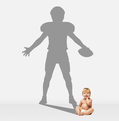 Little baby boy in deaper dreaming of becoming famous american football player