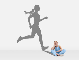 Little girl, child dreaming about future of professional athlete