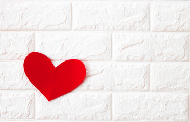 red paper heart on white background with copy space, love concept