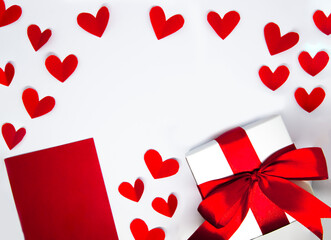 red paper hearts, red note and gift box on white background. Valentine's Day. Love Concept background