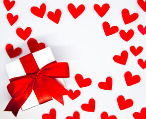 red paper hearts and gift box on white background. Valentine's Day. Love Concept background