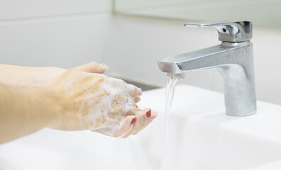 Covid-19 Coronavirus pandemic prevention washing hands with soap. Hygiene concept. 