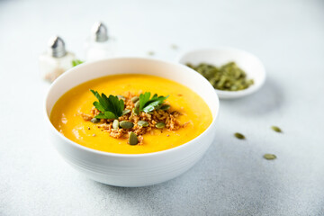 Traditional pumpkin soup with seeds and parsley
