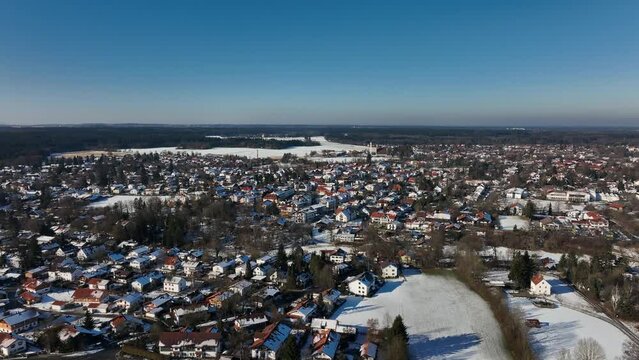 Winter village from above - slow reveal flight backwards over a snowy little town