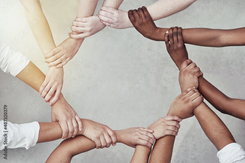 Poster we are more powerful together. shot of a group of hands holding on to each other.