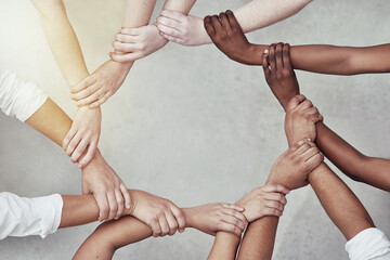 We are more powerful together. Shot of a group of hands holding on to each other.