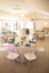 banquet table is decorated with plates, cutlery, glasses, candles and flower arrangements