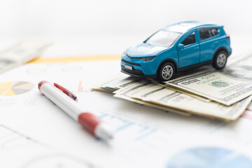 Front view of a blue toy car on sheets drawings