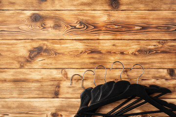 Composition with clothes hangers on wooden background.