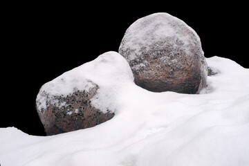 natural stone in snow isolated on black background